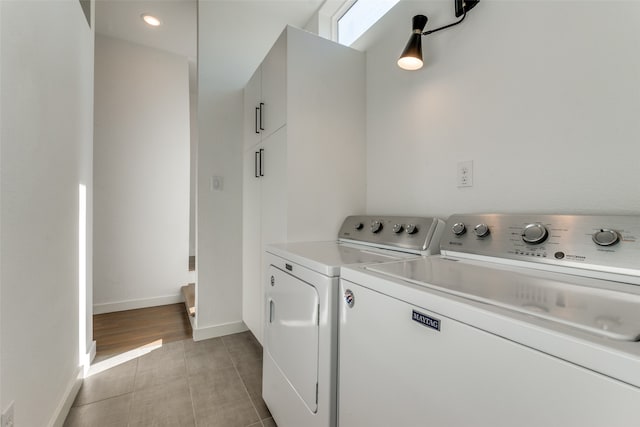 laundry room with light tile patterned floors and washer and dryer