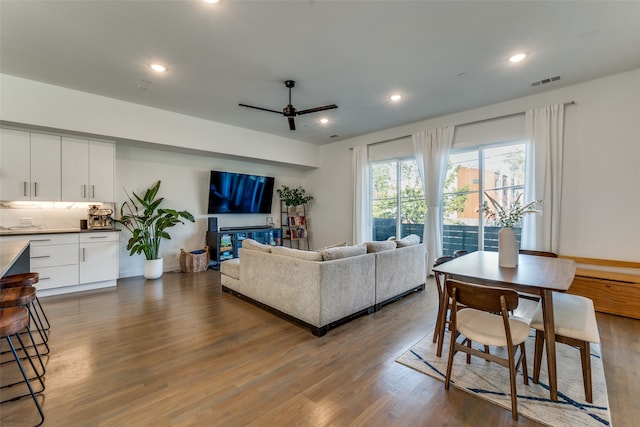 living room featuring hardwood / wood-style flooring and ceiling fan