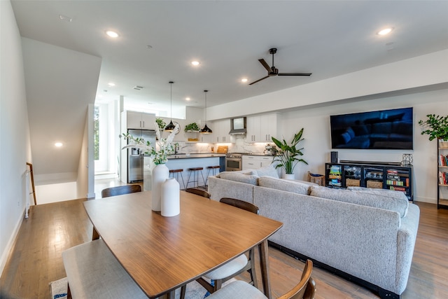 dining room with ceiling fan and light wood-type flooring