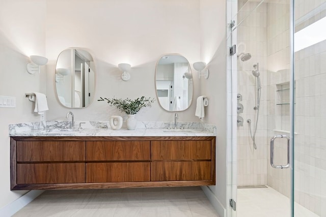 bathroom with tile patterned flooring, vanity, and a shower with door