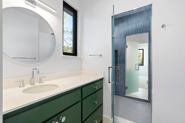 bathroom with vanity and a shower with door