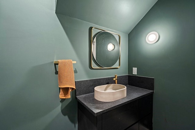 bathroom with vanity and lofted ceiling