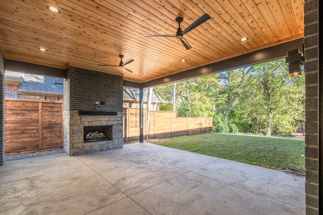 view of patio / terrace featuring an outdoor stone fireplace and ceiling fan