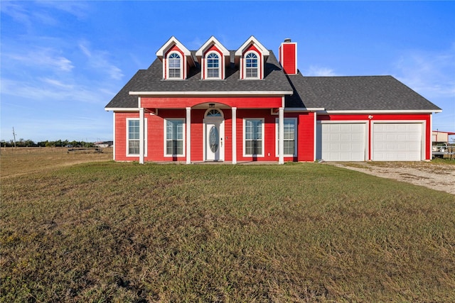 new england style home with a garage and a front lawn