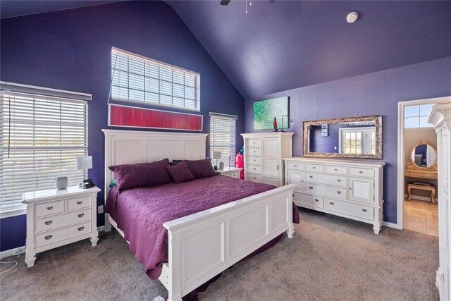 carpeted bedroom with high vaulted ceiling