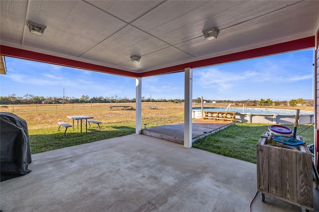 view of patio / terrace with a wooden deck and a rural view