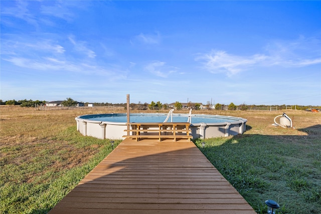 view of pool with a yard