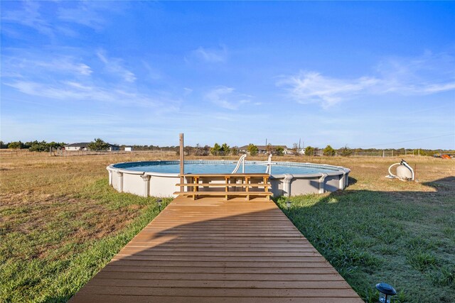 view of pool with a yard