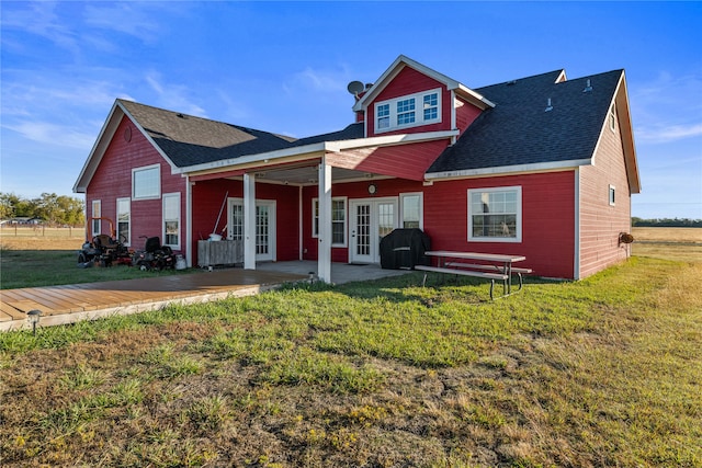 back of house with a lawn and french doors