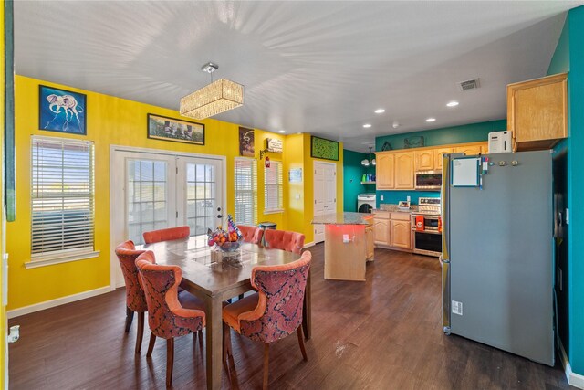 dining area with washer / clothes dryer, dark hardwood / wood-style flooring, and french doors