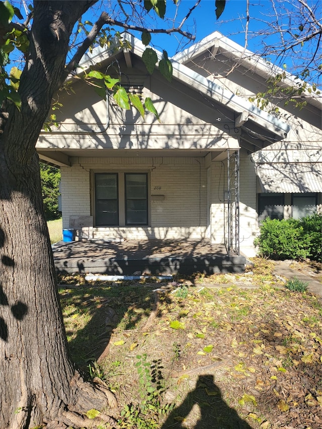 view of side of property featuring a porch