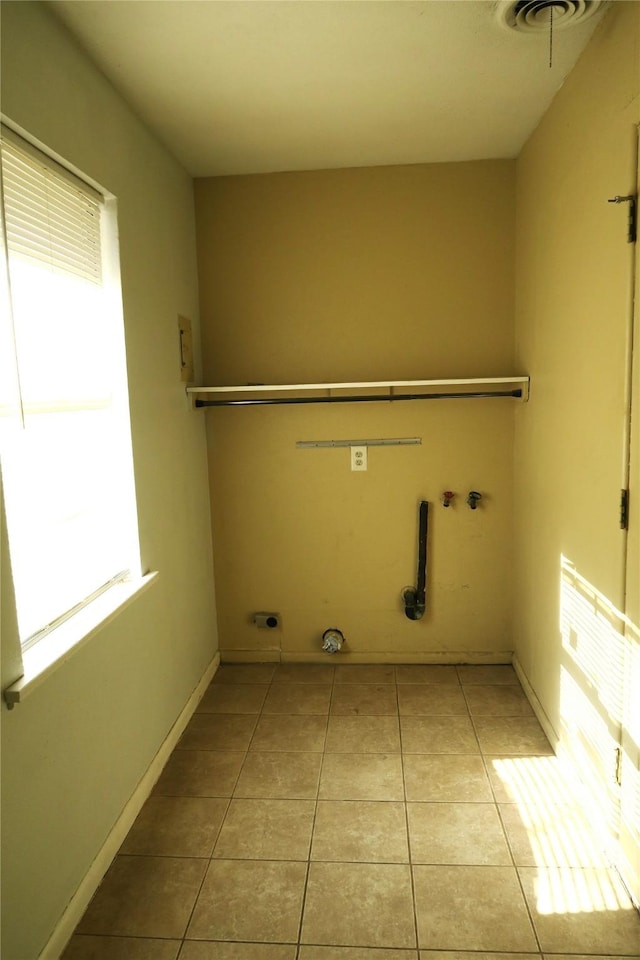 washroom with hookup for an electric dryer, hookup for a gas dryer, light tile patterned flooring, and hookup for a washing machine