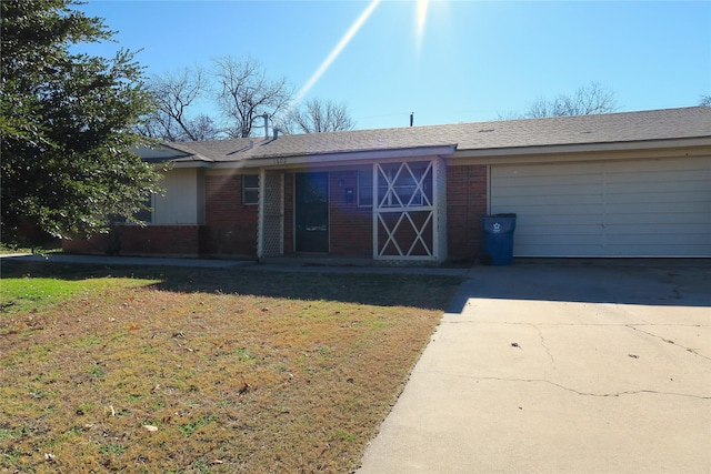 entrance to property featuring a lawn and a garage