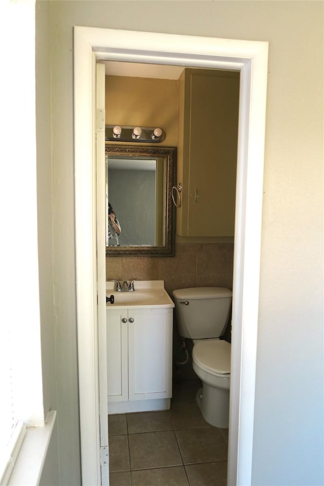 bathroom featuring tile patterned floors, vanity, and toilet