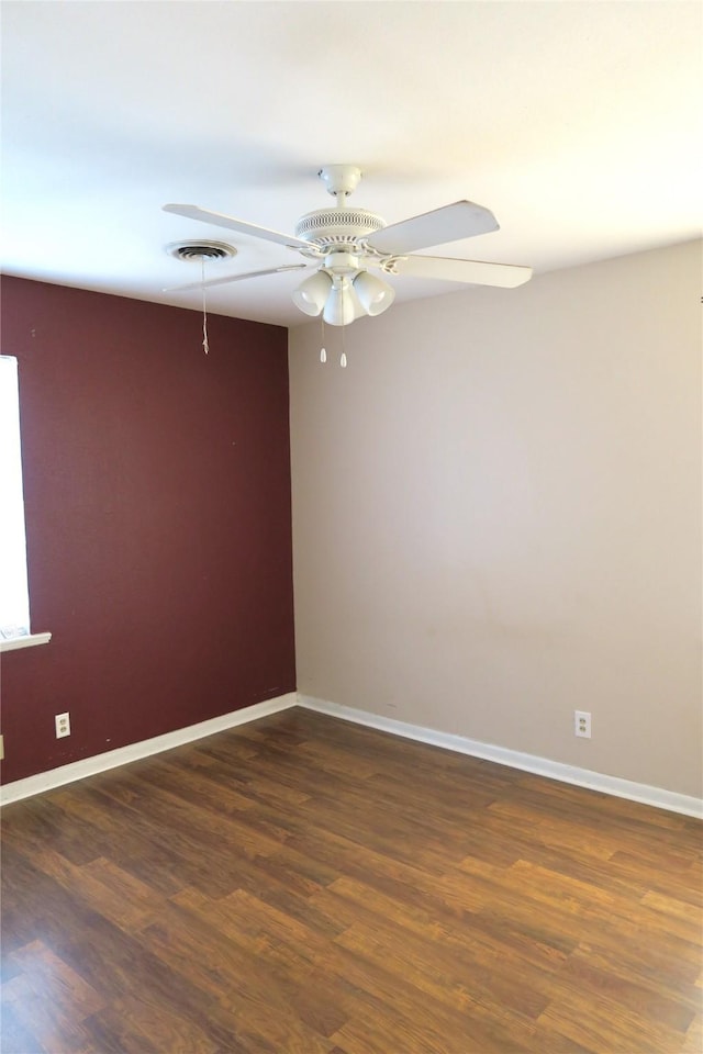 spare room with ceiling fan and dark hardwood / wood-style floors