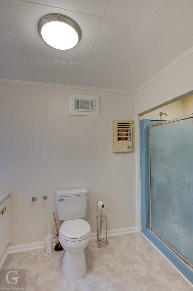 bathroom featuring vanity, wood walls, toilet, ornamental molding, and heating unit