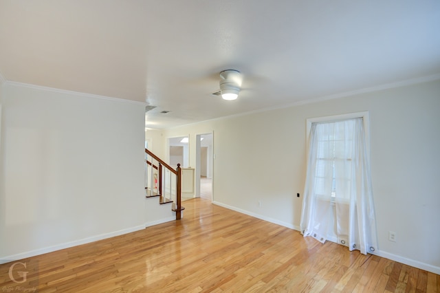 spare room with crown molding, ceiling fan, and light hardwood / wood-style floors