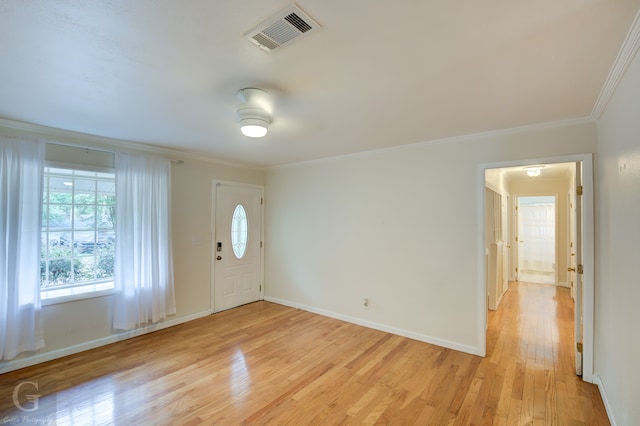 entrance foyer featuring light hardwood / wood-style flooring and ornamental molding