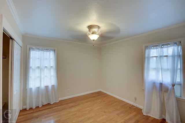 unfurnished room with light hardwood / wood-style floors, ceiling fan, and ornamental molding