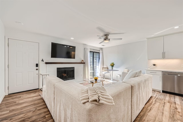 living room with ceiling fan and light hardwood / wood-style floors