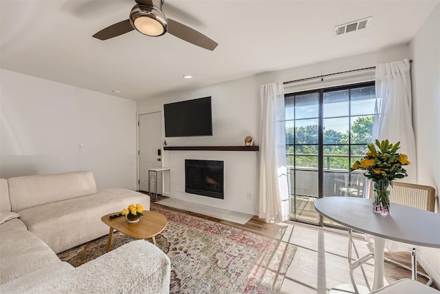 living room with ceiling fan and light hardwood / wood-style floors