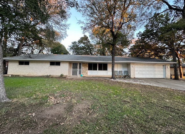 single story home featuring a front yard and a garage