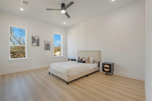 bedroom featuring multiple windows, ceiling fan, and light hardwood / wood-style floors