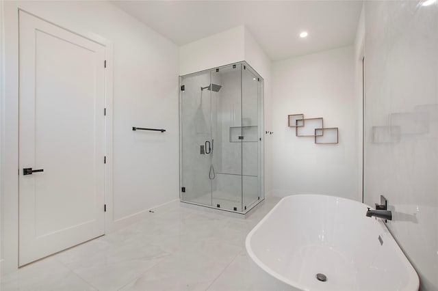 bathroom with shower with separate bathtub