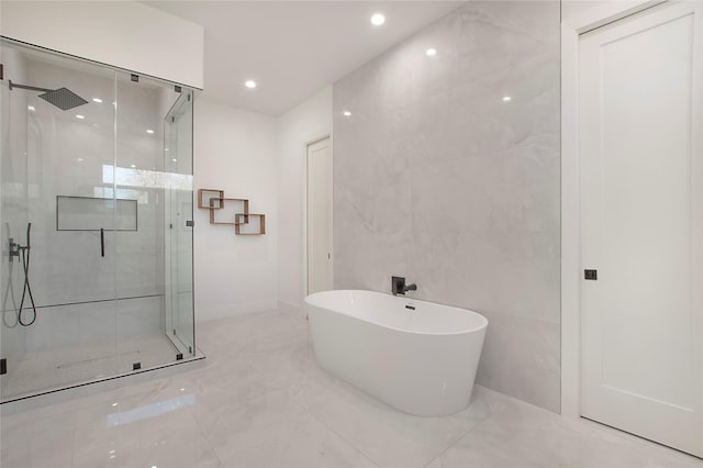 bathroom with independent shower and bath and tile walls