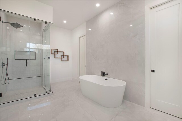 bathroom with independent shower and bath and tile walls