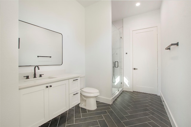 bathroom featuring vanity, toilet, and walk in shower