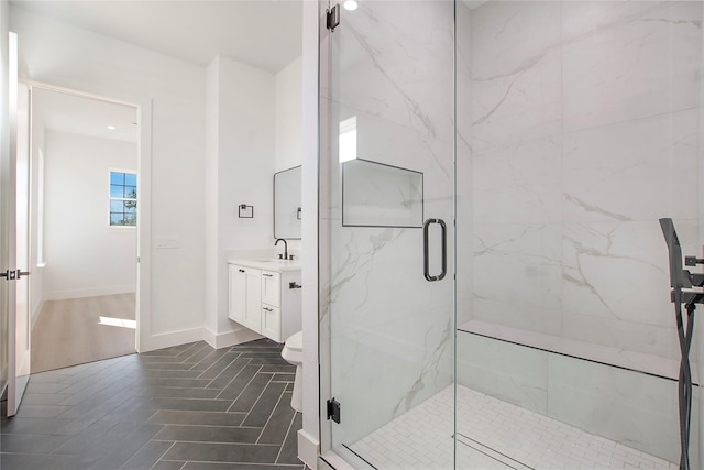 bathroom with vanity, an enclosed shower, and toilet