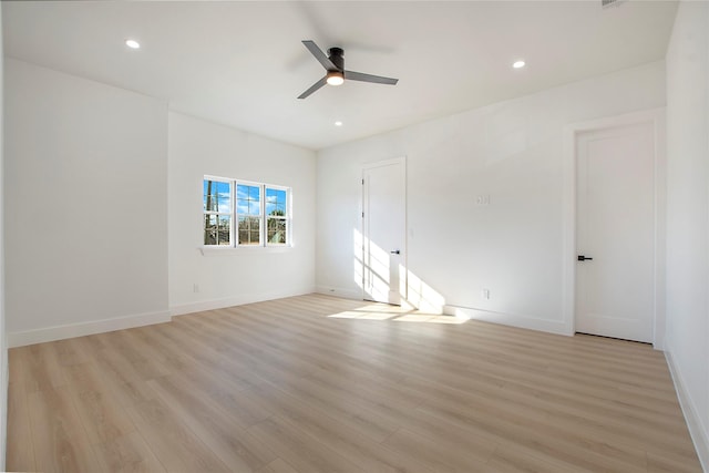 spare room with light hardwood / wood-style flooring and ceiling fan