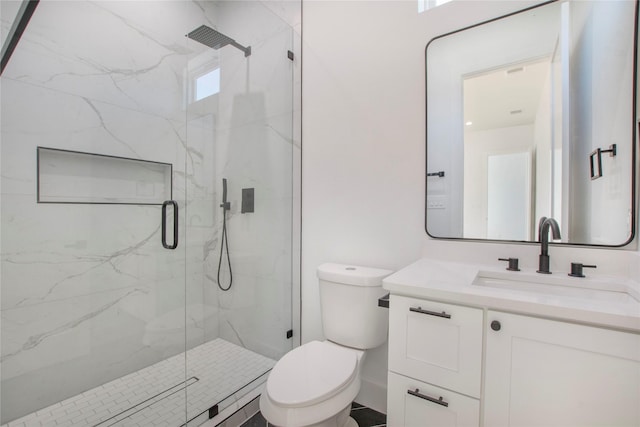 bathroom with vanity, toilet, and a shower with shower door