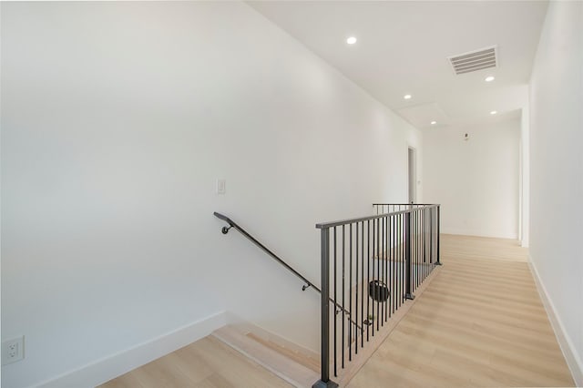 stairs with hardwood / wood-style flooring