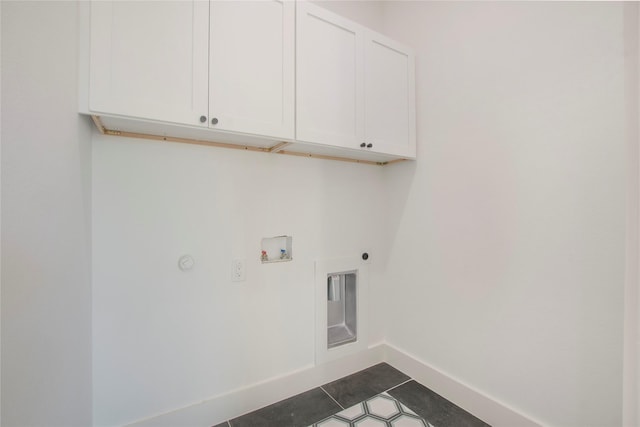 clothes washing area featuring electric dryer hookup, cabinets, and washer hookup