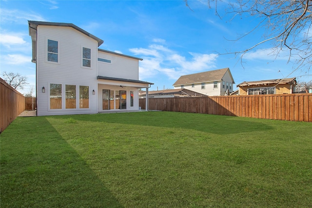 rear view of property featuring a yard