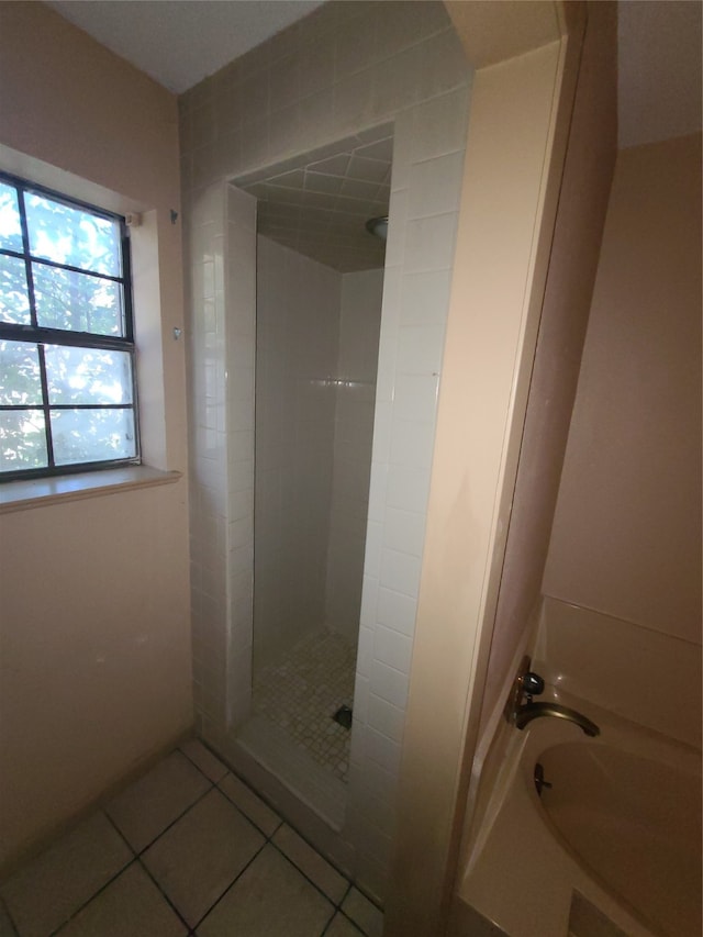 bathroom featuring tile patterned floors and independent shower and bath