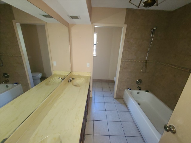 full bathroom with tile patterned flooring, vanity, toilet, and tiled shower / bath