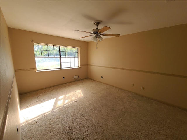 unfurnished room featuring ceiling fan and carpet floors