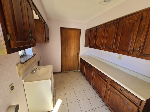 kitchen with sink and light tile patterned floors