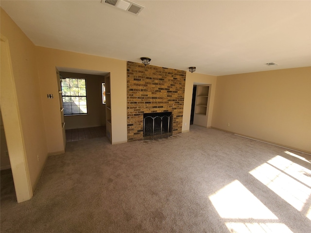 unfurnished living room with a fireplace and carpet floors