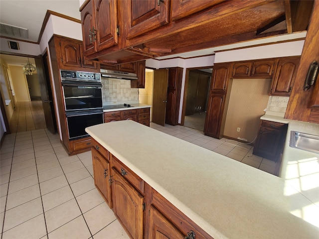 kitchen featuring tasteful backsplash, sink, light tile patterned flooring, and black appliances