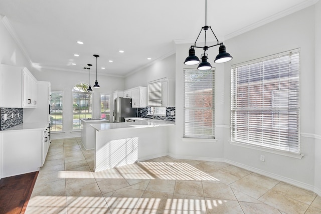 1920 Templehill Dr, Plano, TX 75075 - kitchen with freestanding refrigerator, tasteful backsplash, light countertops, crown molding, and white cabinetry