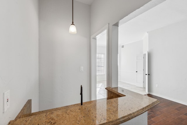 1920 Templehill Dr, Plano, TX 75075 - kitchen with dark wood-style floors, light stone counters, and hanging light fixtures