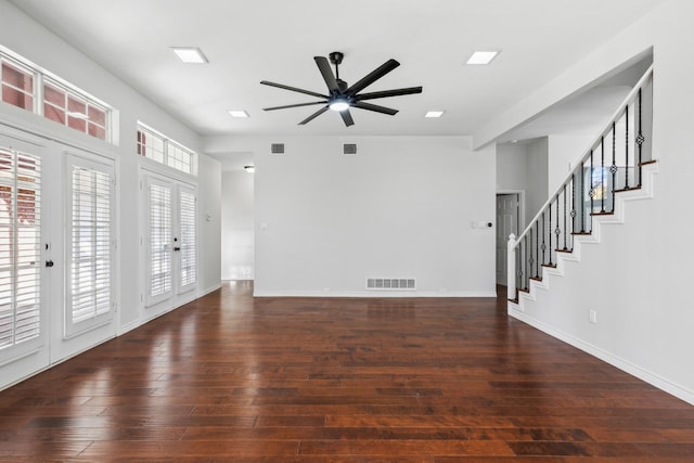 unfurnished living room featuring ceiling fan and dark hardwood / wood-style floors