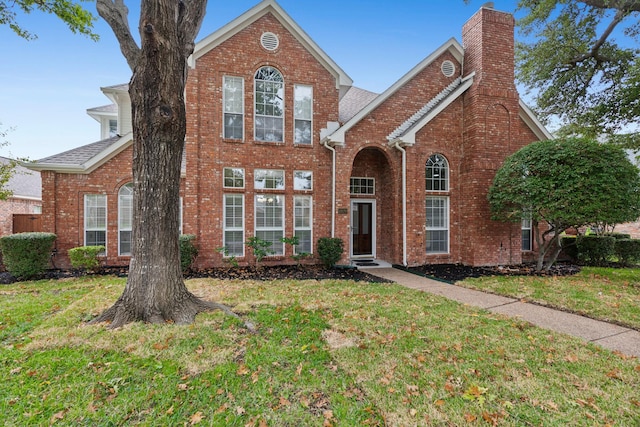 1920 Templehill Dr, Plano, TX 75075 - traditional-style house featuring a chimney, a front lawn, and brick siding