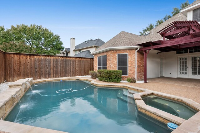 view of pool featuring an in ground hot tub, french doors, and pool water feature