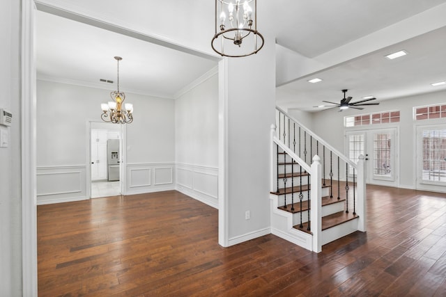 stairs featuring hardwood / wood-style flooring, crown molding, and ceiling fan with notable chandelier