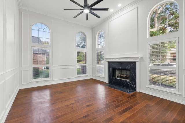 1920 Templehill Dr, Plano, TX 75075 - unfurnished living room featuring ornamental molding, ceiling fan, wood finished floors, a premium fireplace, and a decorative wall